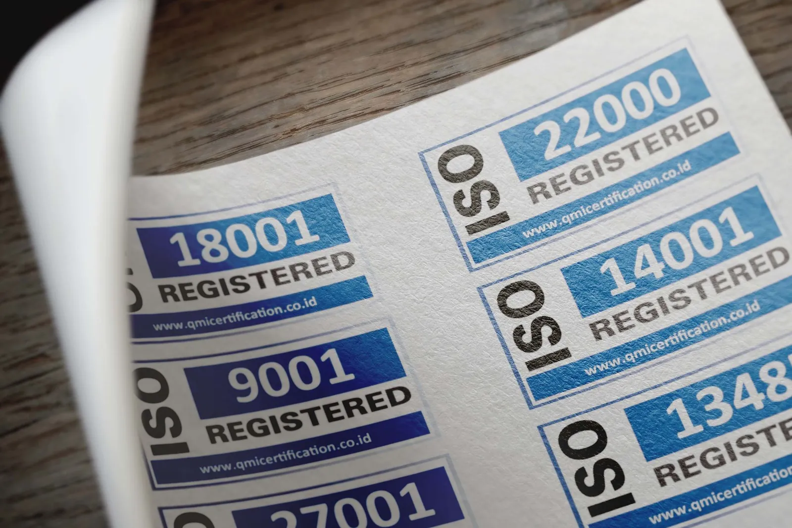 Printed sheet showing ISO 9001, ISO 14001 and ISO 22000 certification marks for a quality management system.