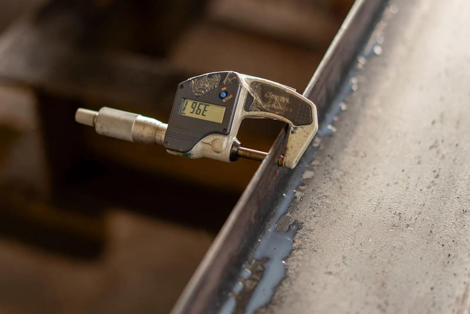 Measuring the thickness of an aluminum sheet with a caliper to confirm its gauge